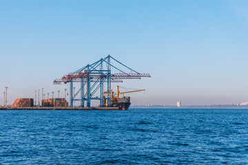 Fototapeta premium Loading cargo in the seaport. Marine industrial trade port. Black Sea. Export and import by sea. City of Odessa, Ukraine