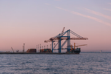 Fototapeta na wymiar Loading cargo in the seaport. Marine industrial trade port. Black Sea. Export and import by sea. City of Odessa, Ukraine
