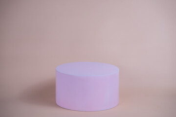Empty podium for display cosmetic product. Platform arrangement in pink pastel color in trendy minimalist style. Composition of cylinders and cubes layout for feminine background