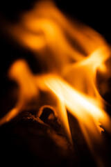 Fire close-up and red orange yellow color detail texture and abstract shape on black background