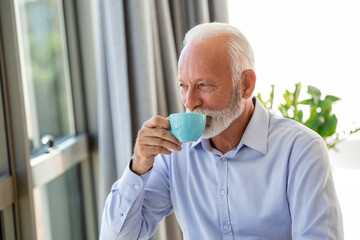 Shot of a senior financial businessman sitting in his office and drinking a cup of coffee while taking a break.