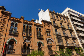 Seville, Spain, September 11, 2021: Beautiful brick facade with decoration, and balconies at Calle Martín Villa Street in Seville, Spain.