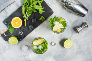 Refreshing summer alcoholic cocktail mojito with ice, fresh mint and lime. Top view