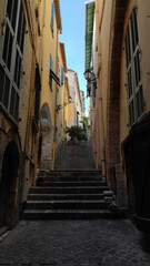 Fototapeta na wymiar Narrow street and stairs Escalinada del Pountin street in Villefranche-sur-Mer, France.