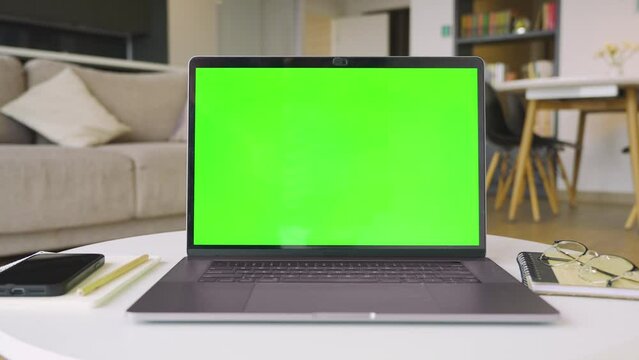 Mockup image of laptop computer with green screen chromakey for advertising app.