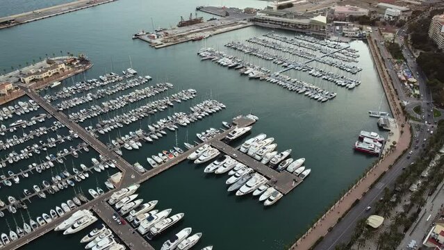Aerial View of Alicante, Spain, Boats in Harbor and Traffic on Coastal Avenue on Summer Evening, Drone Shot