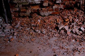 pile of bricks lying around, ruined wall in abandoned building, shelter, concept of destruction of...