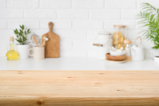 Wood table top on blur kitchen background for product montage