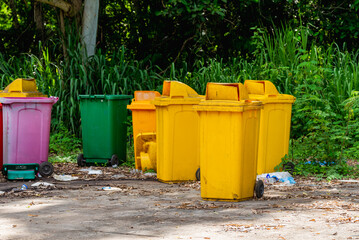 yellow bin Several plastic bins are left in the garbage collection area, causing pollution.