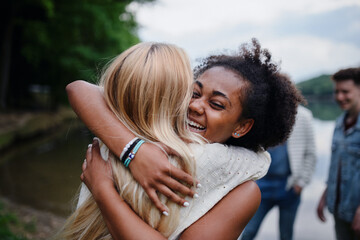 Friends having fun together at park lauging and hugging, Friendship and lifestyle concepts