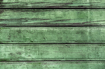 Texture of old wooden green shabby planks with cracks and stains. Abstract background of wood table...