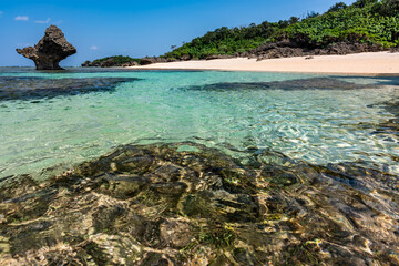 Impressive crystal clear sea waters with glistening surface, sunny day at a paradise beach.