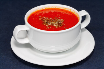 Traditional tomato cream soup in a white bowl