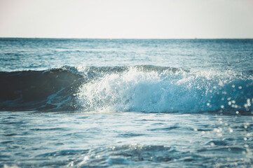 Close Up View Of Rolling Waves With Splash Of Tropical Beach Village