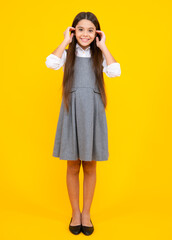 Full length of her she attractive pretty lovely cute cheerful cheery teenager child girl isolated over vivid yellow background.