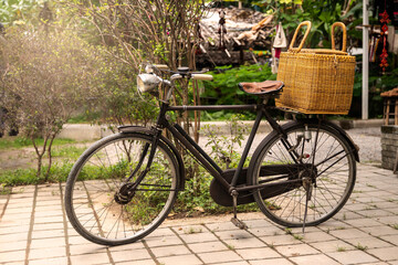 Vintage bicycle with a basketin front of a clothing store