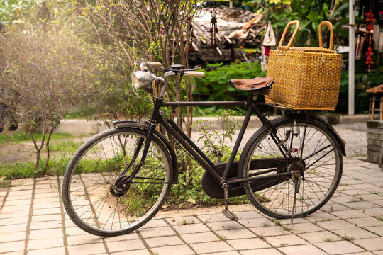 Vintage bicycle with a basketin front of a clothing store
