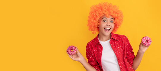 surprised kid in fancy orange wig hair hold sweet glazed donut, surprise. Teenager child with...