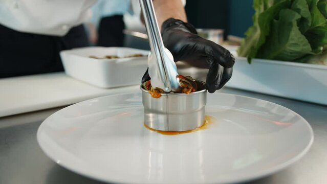 The chef serves ratatouille on a plate. Exquisite dish in an expensive restaurant.