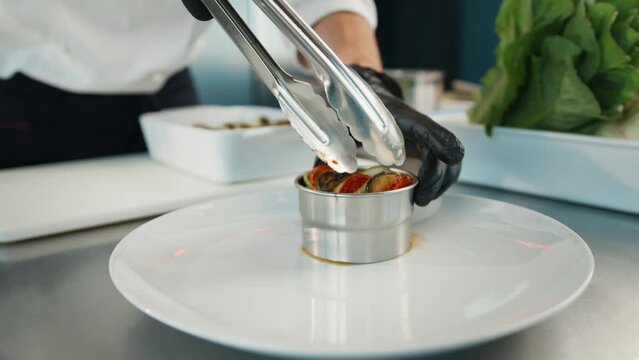 The chef serves ratatouille on a plate. Exquisite dish in an expensive restaurant.