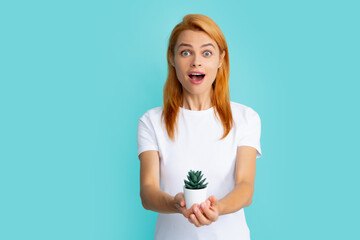 Fototapeta premium Beautiful woman holding small cactus, happy and smile.
