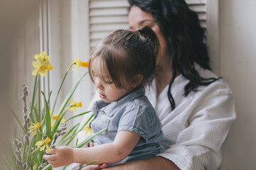 Happy woman and her little daughter in the living room. Mother day concept. High quality photo