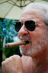 handsome rich man smoking cigar. old man with cigar. man smoke cuban cigar