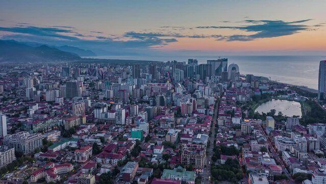 Aerial Time Lapse Of Seaside City At Evening Dawn Shot From Drone