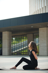 Girl doing yoga school age in sports form shows the elements of sports and asanas.