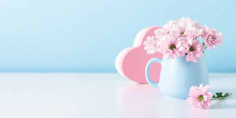 Pink flowers in cup on blue wall background. Valentine's Day, Happy Woman's Day, Mother's Day, Birthday, Wedding