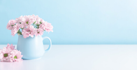Pink flowers in cup on blue wall background. Valentine's Day, Happy Woman's Day, Mother's Day,...