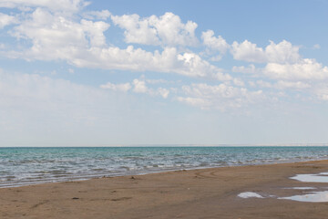 Sandy beach with blue sea and blue sky and white cloud is beautiful on the coast. beautiful blue ocean shore outdoor nature landscape water background.