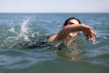 Happy pregnant woman on sea vacation. Future happy mother bathes in warm sea water
