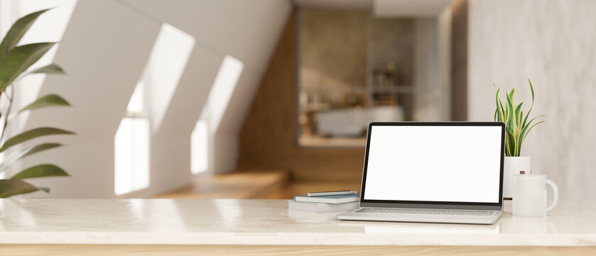 Tabletop with laptop mockup and copy space over blurred minimal home corridor in background