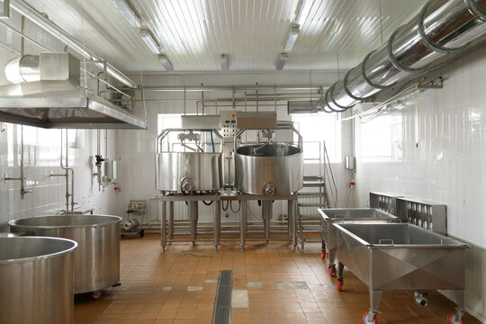 Dairy cheese factory interior with industrial appliances. Milk pasteurization, tank, bath and pipes