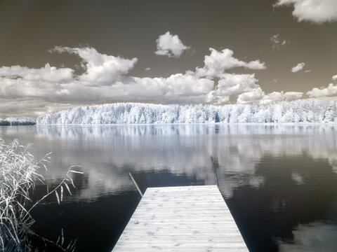 infrared surreal landscape, lake with wooden footbridge, infrared photo snowy tree amazing nature lake reflection