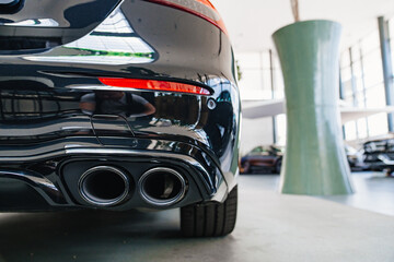 the exhaust pipe of the new black car. 