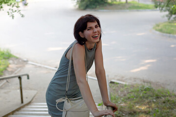 A cheerful woman rolls with laughter after hearing a joke from a friend.