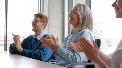 Business audience people group smiling applauding sitting at conference.