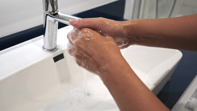 Washing hands rubbing with soap voman for corona virus prevention, hygiene to stop spreading covid omicron