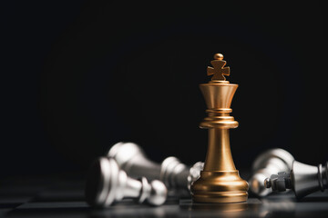 Stand of golden king chess and fallen silver king chess. Winner of business competition and...
