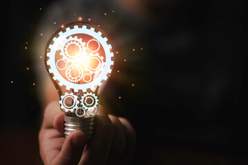 Mechanic gear inside of lightbulb with glowing for creative thinking idea and problem solving...