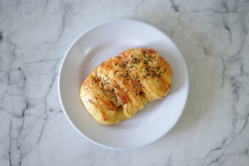 Sausage buns bread. Soft baked bun (dough) stuffed with sausage for fast food breakfast or coffee break. Sausage roll, (hot dog).
With mayo, tomato sauce, mozarella cheese and parsley topping
