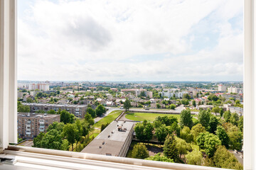 View from the window from a great height to a green park with a beautiful sky