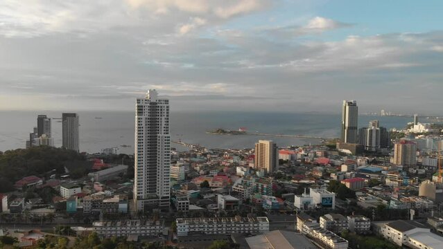 Aerial view from Koh Larn of Thailand overlooks the sea and the coast of Si Racha City during day time amongst the blue sky. Chonburi, Thailand