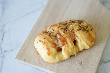 Sausage buns bread. Soft baked bun (dough) stuffed with sausage for fast food breakfast or coffee break. Sausage roll, (hot dog).
With mayo, tomato sauce, mozarella cheese and parsley topping
