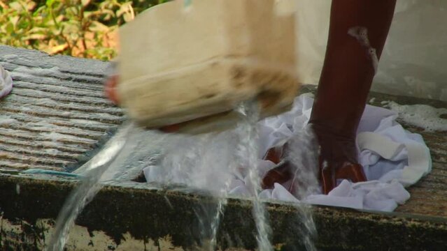 Hand washing clothing with soap and a washboard in Africa, Sao Tome and Principe - no faces