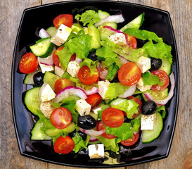 Appetizing Greek salad with fresh juicy vegetables.