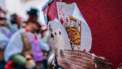 Poker cards on the red hat of a carnival costume, at the Carnival of Cadiz