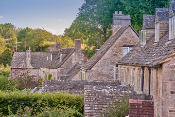 Traditional stone clad roofs on Cotswold cottages in Bisley